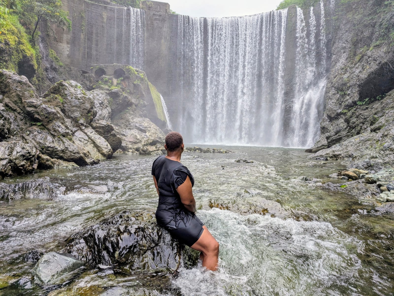 Reggae Falls waterfall in St. Thomas surrounded by lush greenery.