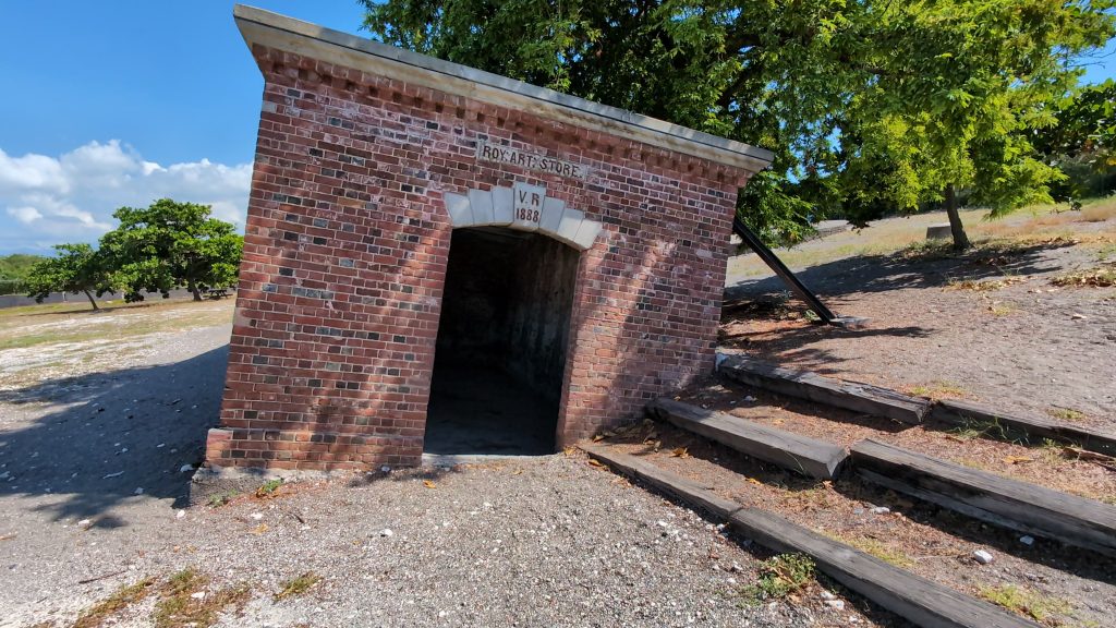 “Inside Giddy House at Fort Charles, leaning building caused by the 1907 earthquake”