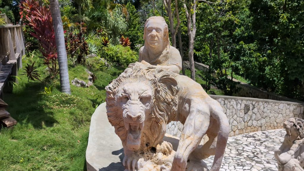 "Stone sculpture blending with tropical forest at Jamaica Giants”