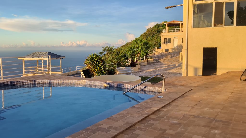 “Outdoor pool at Sea Coast Inn overlooking the Caribbean Sea”