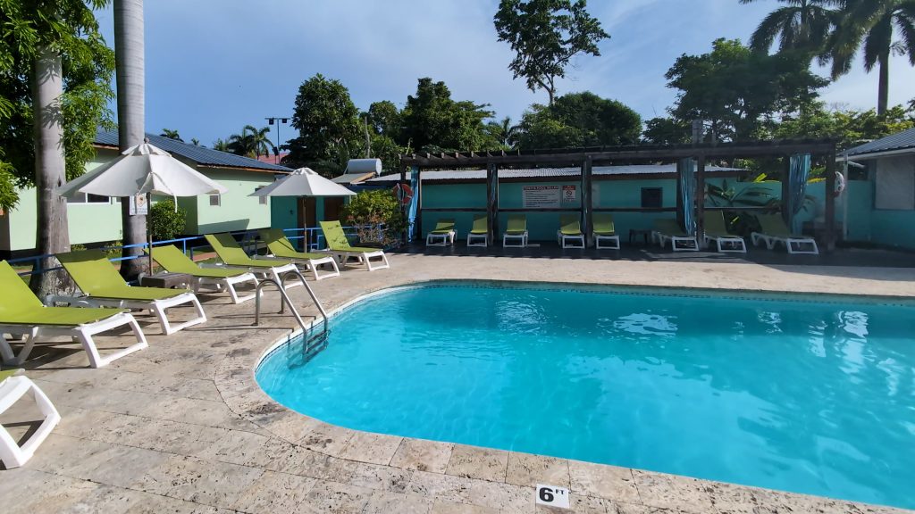 “Toby’s Resort pool area with guests enjoying the sun”
