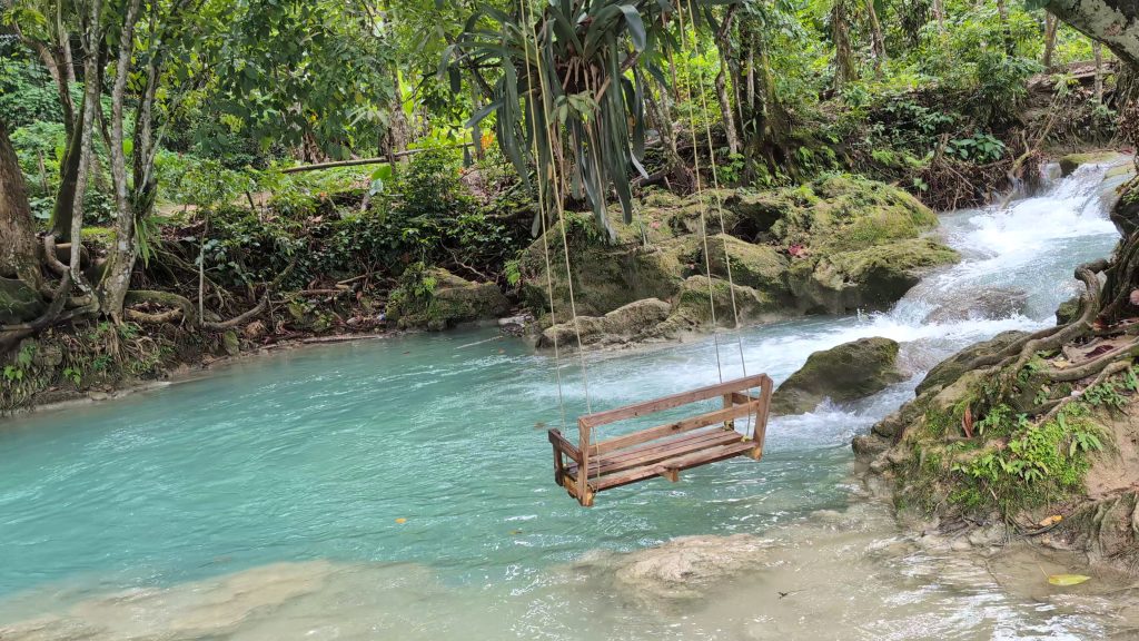 Blue green river swimming area at Spring Paradise St Ann Jamaica surrounded by trees